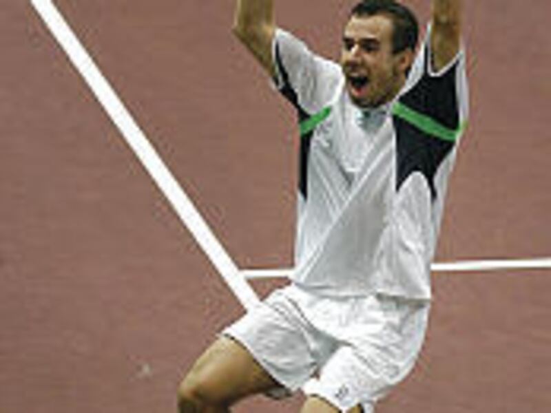 Slovakia's Dominik Hrbaty celebrates after defeating Ivan Ljubicic of Croatia. Croatia hung on to win the Davis Cup crown.