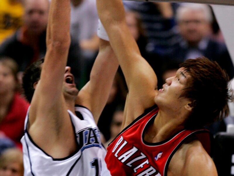 Portland Trail Blazers center Ha Seung-Jin (5), of South Korea, reaches through the hoop to block the ball by Utah Jazz center Mehmet Okur.