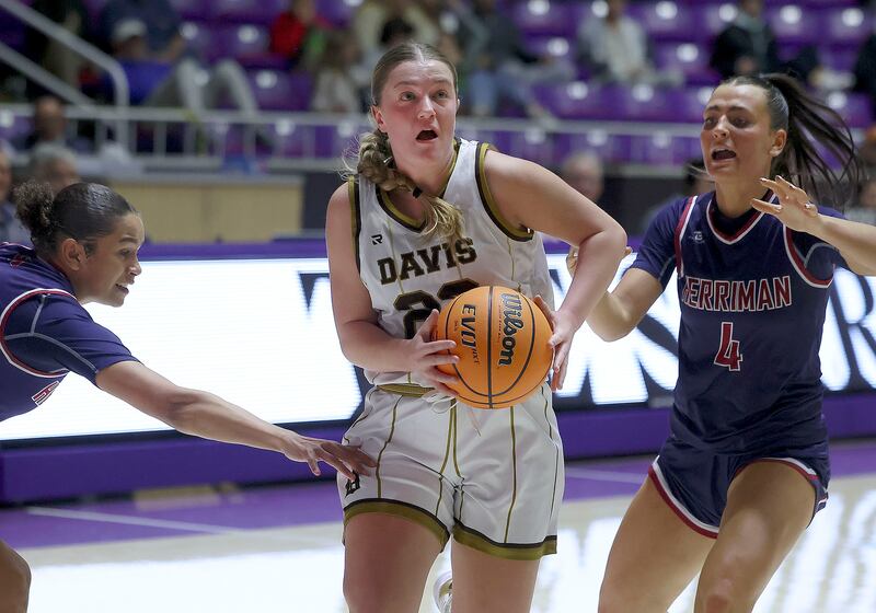Davis’ Kate Richards, wearing white, drives against Herriman’s Halli Burbridge