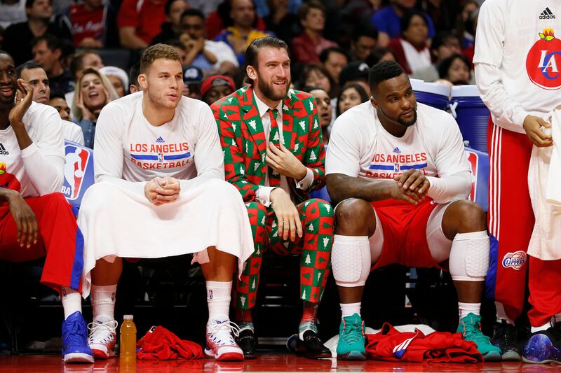 Los Angeles Clippers’ Spencer Hawes, center, wears a Christmas themed suit as he sits on the bench during a game on Dec. 25, 2014.