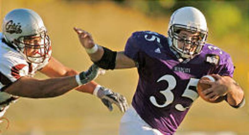 Weber State's Nick Chournos (35) tries to elude a Montana defender during this past Saturday's game in Ogden.