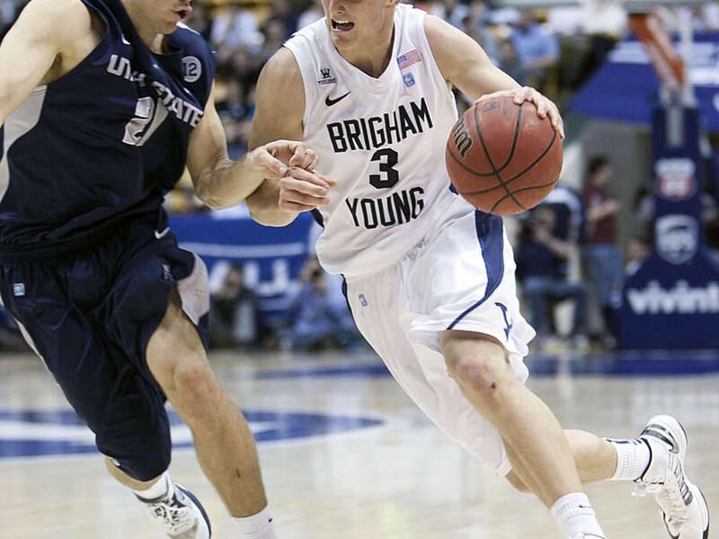 BYU's Tyler Haws drives on USU's Spencer Butterfield as BYU and Utah State play Tuesday, Feb. 19, 2013 at BYU in the Marriott Center.