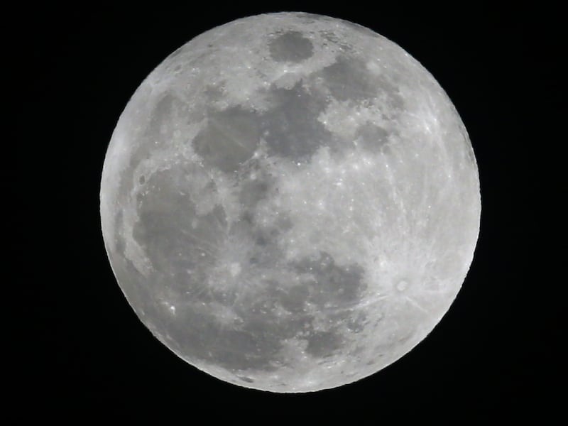 The full snow moon lights up the night sky over Lawrence, Kan.