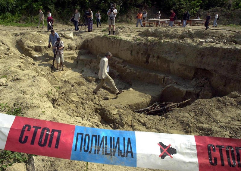 FILE - This is July 9, 2001 file photo of a mass grave which used to contain bodies of Kosovo Albanians at a police compound in Belgrade suburb of Batajnica, Serbia. The banner in front of the hole reads ``Stop Police.'' Amnesty International and regional