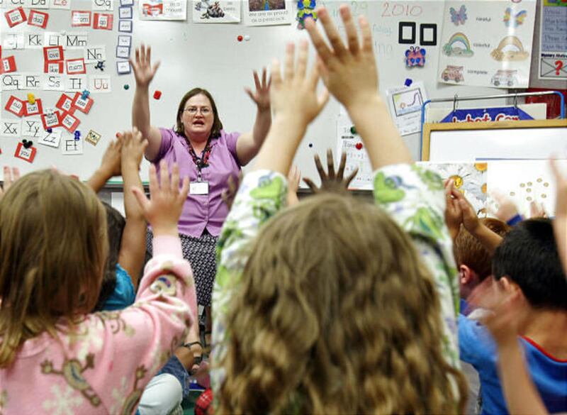 FILE— Michelle Foote sings a song with her Spanish-immersion kindergarten class at Riverside Elementary School in West Jordan. Her class is one of many in Utah\'s new experiment.