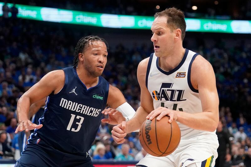 Dallas’ Jalen Brunson defends as Utah’s Bojan Bogdanovic works to the basket during Game 1 of first-round playoff series.