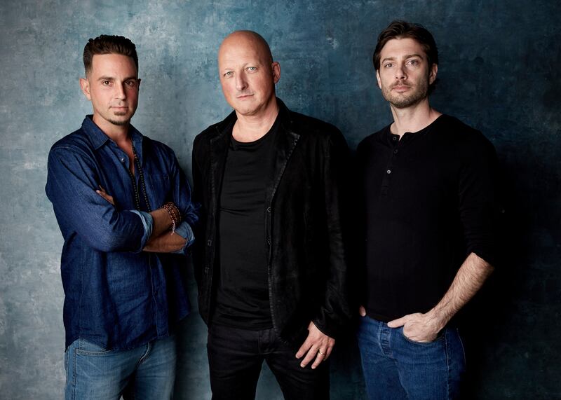Wade Robson, from left, director Dan Reed and James Safechuck pose for a portrait to promote the film "Leaving Neverland" at the Salesforce Music Lodge during the Sundance Film Festival on Thursday, Jan. 24, 2019, in Park City, Utah.