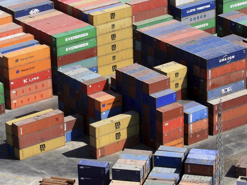 FILE-In this March 16, 2011 file photo, a container truck leaves from the container port in Dalian, in northeastern China's Liaoning province. China's export growth fell in October amid weak U.S. and European demand while imports gained, but its trade sur