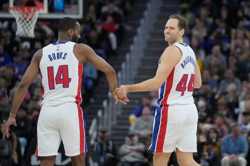 Detroit Pistons guard Alec Burks (14) and forward Bojan Bogdanovic during a game against the Golden State Warriors .