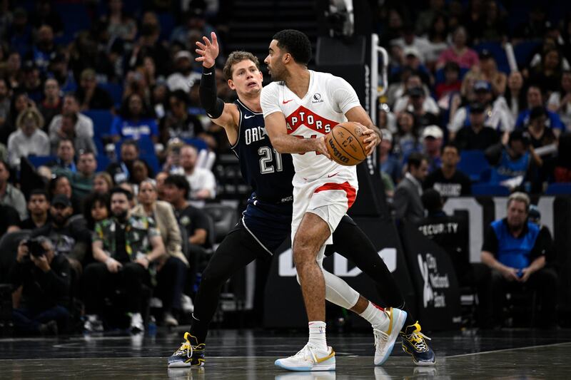 Toronto Raptors center Jontay Porter, right, is defended by Orlando Magic center Moritz Wagner (21) during game, Sunday, March 17, 2024, in Orlando, Fla.
