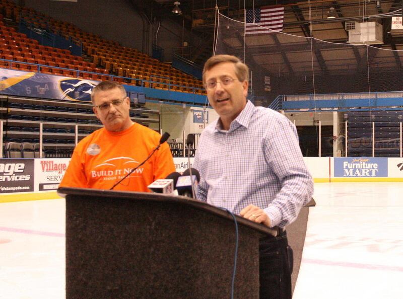 In this Nov. 8, 2011, photo, Sioux Falls Mayor Mike Huether, right, speaks at a press conference after voters in Sioux Falls approved a measure to build a $115 million events center. Sioux Falls councilman Jim Entenman is at left.