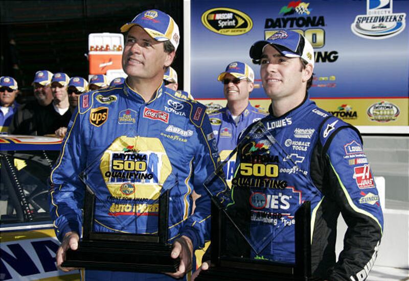 NASCAR drivers Michael Waltrip and Jimmie Johnson, right, pose for photos with the Front Row trophies Sunday, after they finished Daytona 500 qualifications with the top speeds.
