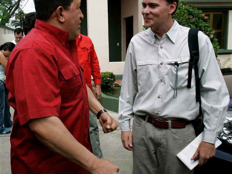 In this 2007 photo, Venezuelan President Hugo Chavez speaks with Ian James in San Fernando de Apure, Venezuela.