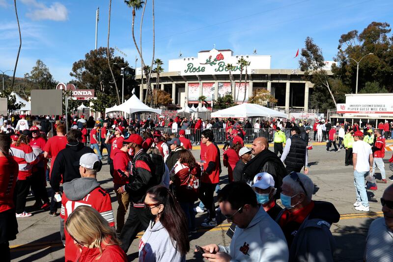 Utah and Ohio State fans walk around outside the 108th Rose Bowl game in 2022.