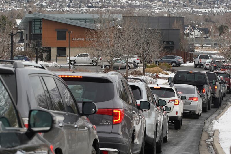 A line of cars wait for COVID tests.