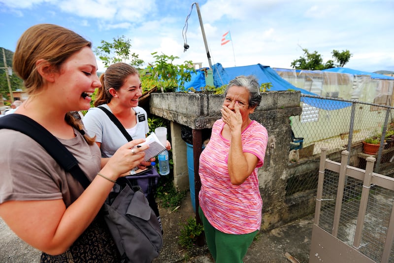 Sisters Mary Ruff from Middle, Utah, and Erin Bianucci from Layton, Utah, talk with Luci Morales in Puerto Rico on Saturday, Feb. 17, 2018.