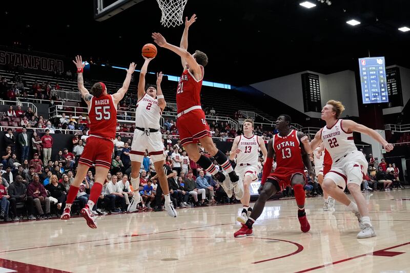 Stanford guard Andrej Stojakovic (2) drives between Utah guards Gabe Madsen (55) and Luka Tarlac (21) on Jan. 14, 2024.
