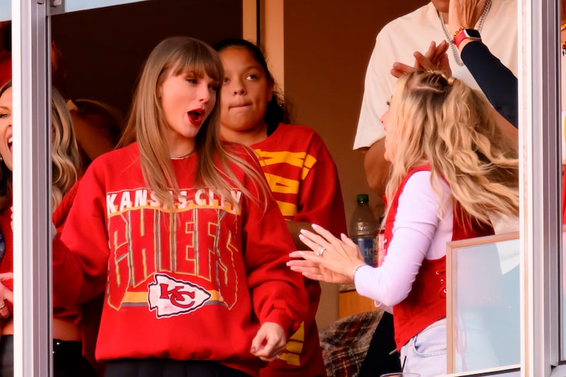 Taylor Swift, wearing a Kansas City Chief’s shirt, and Brittany Mahomes react to a Travis Kelce touchdown in Kansas City.