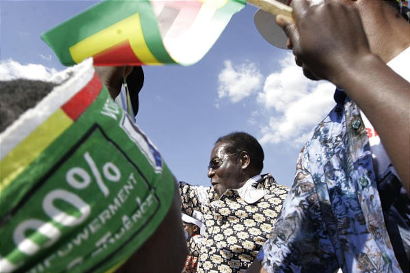 Zimbabwean President Robert Mugabe greets people at a campaign rally in Banket Tuesday. His opponent has quit and fled.
