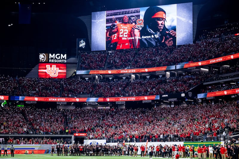 Utah Utes players and fans turn on their flashlights to honor Aaron Lowe and Ty Jordan