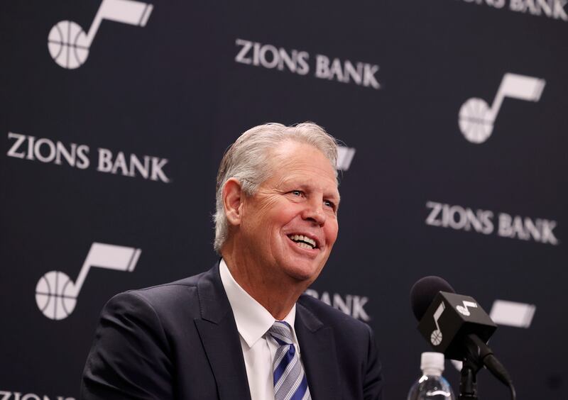 Danny Ainge speaks in front of a black background.