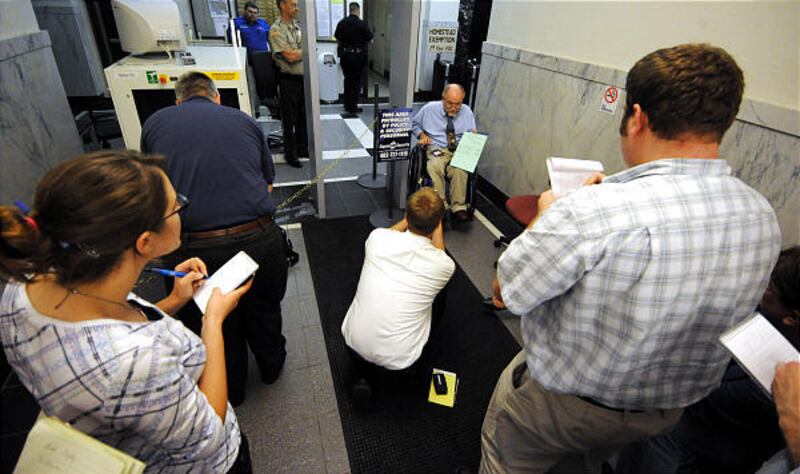Election Commissioner Fred Mytty holds the unofficial results to a special election held Monday in Fremont, Neb.