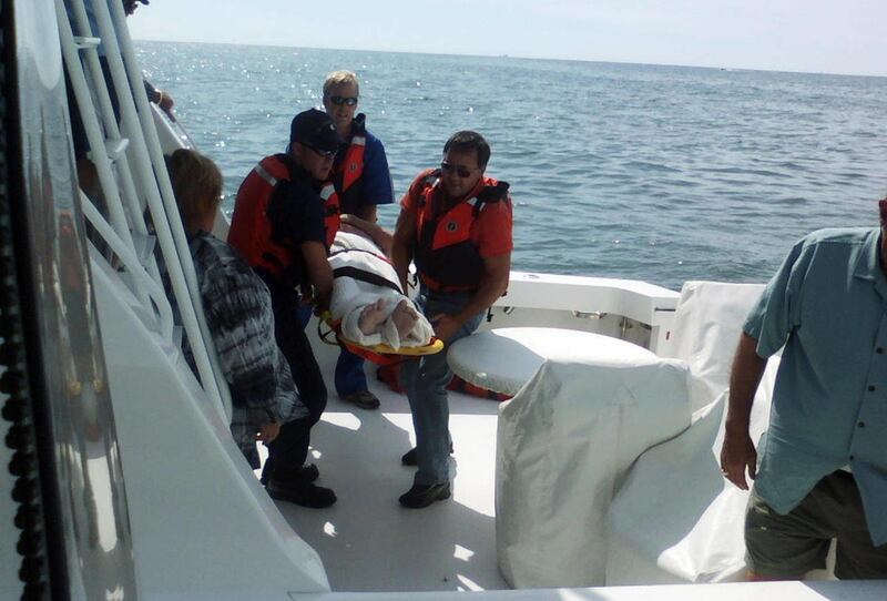 FILE - In this Wednesday, July 27, 2011 file photo provided by the Huron County, Mich., Sheriff's Office, rescuers carry pilot Michael Trapp after he spent 18 hours swimming and treading water without a life jacket, after his small plane went down due to