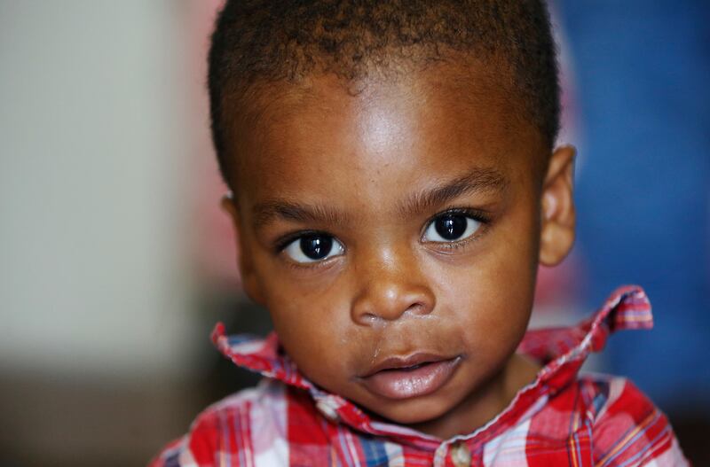 Congolese refugee Benjamin Ngunza, 1, watches his mother in the kitchen of the family apartment in Salt Lake City on Nov. 5, 2017.