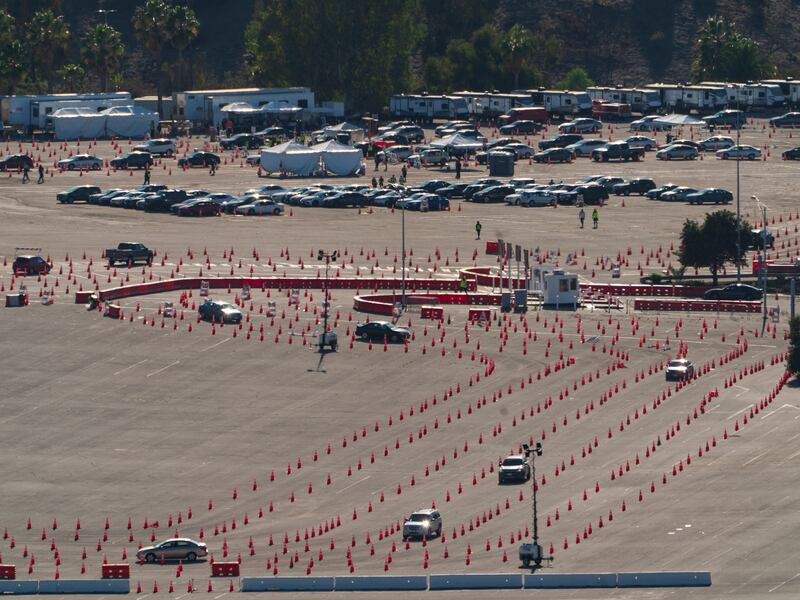 Motorists queue up to take a coronavirus test in a parking lot at Dodger Stadium’s drive-thru testing site in Los Angeles Monday, Jan. 11, 2021.