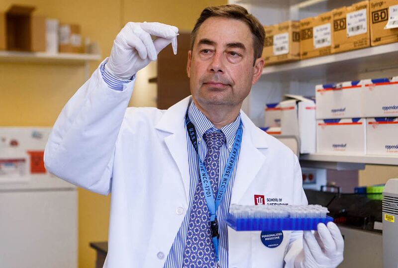Dr. Alexander Niculescu works in a lab at Indiana University in Indianapolis, Ind.