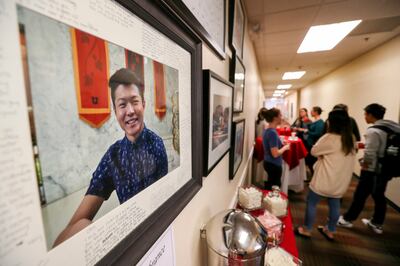 FILE - A framed photo of University of Utah student Chenwei Guo, who was murdered on campus a year ago, hangs in the hallway outside the International Student and Scholar Services office as people gather for an informal memorial for Chenwei in the Univers