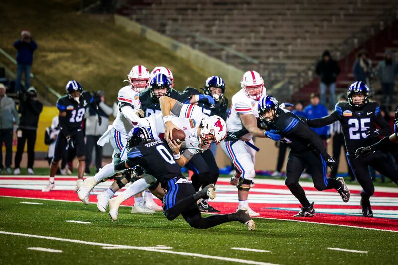 BYU cornerback Jakob Robinson (0) tackles SMU quarterback Tanner Mordecai short of the end zone on a two-point attempt with eight seconds to play in the New Mexico Bowl.
