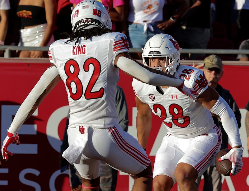 Utah Utes safety Sione Vaki (28) and tight end Landen King (82) celebrate Vaki’s touchdown against USC on Saturday, Oct. 21, 2023.