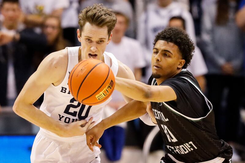 BYU guard Spencer Johnson and Central Methodist guard Trent Lyles battle for ball during game at Marriott Center in Provo.