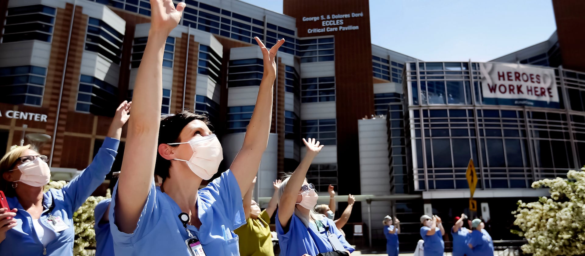 University of Utah Hospital nurse Nikole Ihler waves as Hill Air Force Base’s 388th Fighter Wing fly over the hospital.