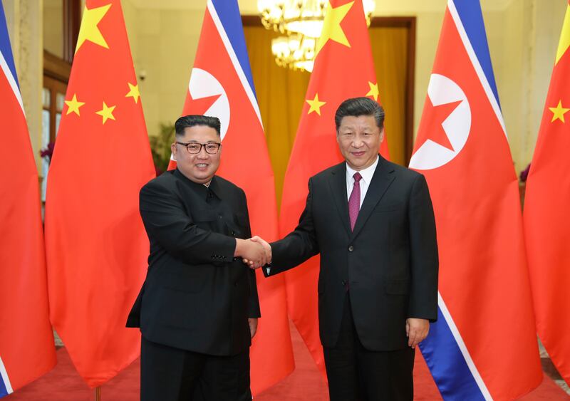 FILE - In this June 19, 2018, file photo released by China's Xinhua News Agency, Chinese President Xi Jinping, right, poses with North Korean leader Kim Jong Un for a photo during a welcome ceremony at the Great Hall of the People in Beijing. U.S. Defense