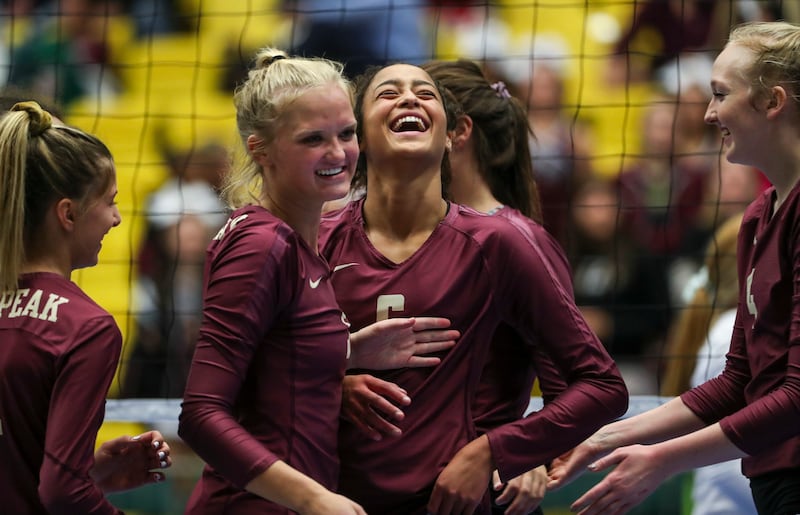 Lone Peak's Tasia Farmer, center, smiles as she celebrates a point with her teammates during match against Northridge during the high school volleyball 6A state tournament at UVUU in Orem on Thursday, Nov. 1, 201