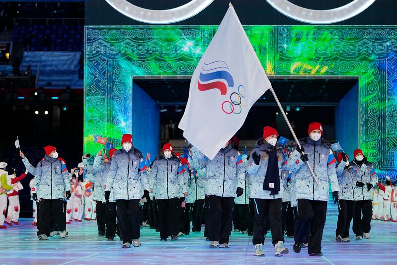 Olga Fatkulina and Vadim Shipachyov, of the Russian Olympic Committee, carry a flag into the stadium during the opening ceremony of the 2022 Winter Olympics in Beijing.