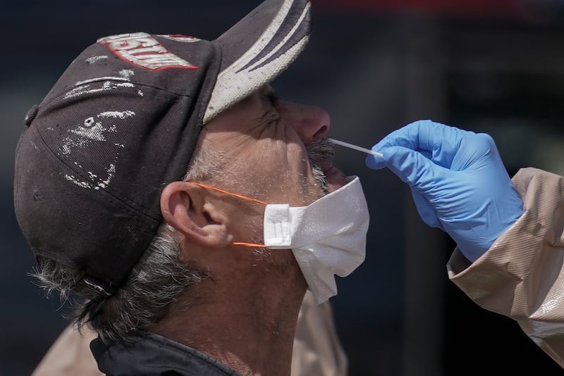 Wisconsin National Guard members administer COVID-19 tests in a parking lot Monday May 11, 2020, in Milwaukee. This was one of two sites in the city to open Monday and offer free testing.