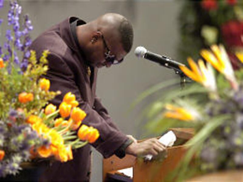 Denver Broncos running back Tatum Bell pauses while speaking at the funeral service for Broncos cornerback Darrent Williams.