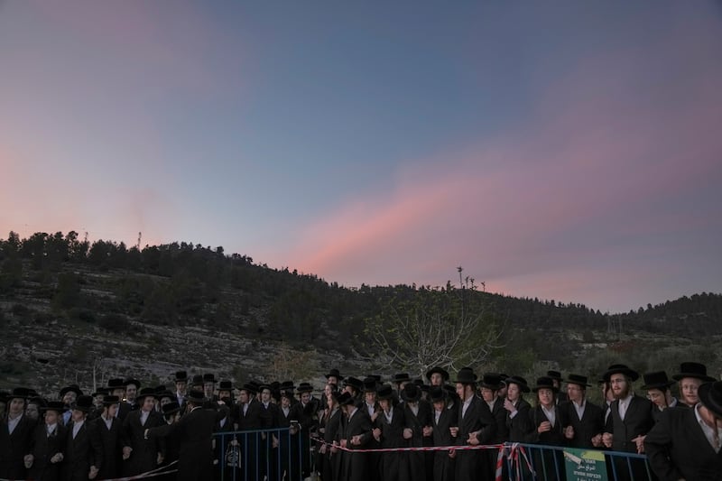 Ultra-Orthodox Jews listen to Rabbi Pinsk Karlin before they collect water from a spring to make matzoh in Jerusalem.