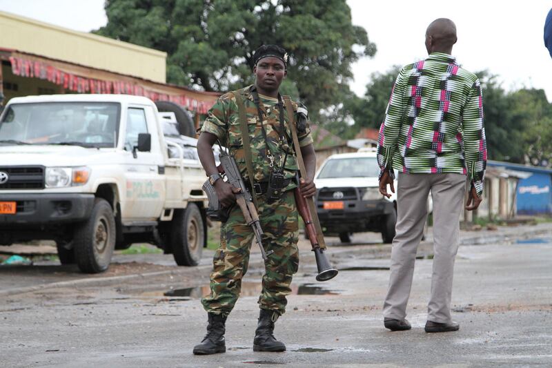 A Burundian soldier with his gun and rocket launcher guard a deserted street in Bujumbura, Burundi, Sunday, Nov. 8, 2015. Three grenades exploded Monday in different parts of Burundi's capital following a night of violence in which five people, includin
