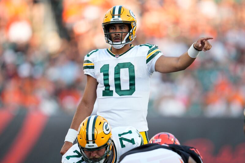 Green Bay Packers quarterback Jordan Love signals against the Cincinnati Bengals during the first half of a preseason NFL football game.