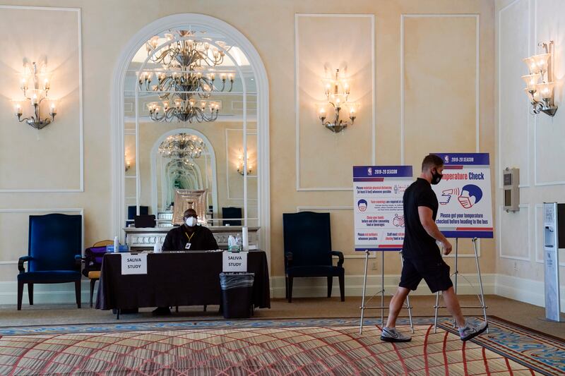 A man enters an NBA COVID-19 testing site, Wednesday, July 29, 2020, in Orlando, Fla., where testing inside the NBA bubble occurs several times a week. The world has changed since the NBA stopped on March 11. For 22 franchises, however, there is a goal that remains in place. The NBA, at long last, is officially back.