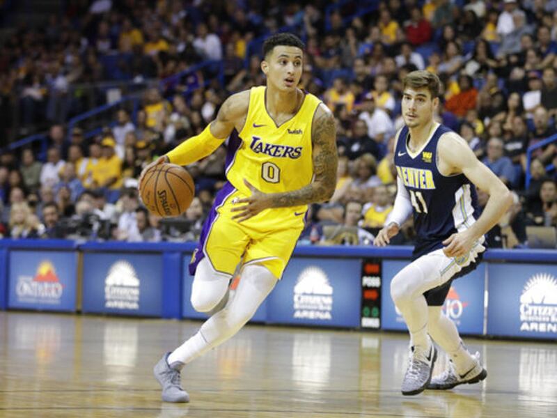 Los Angeles Lakers' Kyle Kuzma drives past Denver Nuggets' Juan Hernangomez during the second half of an NBA preseason basketball game, Wednesday, Oct. 4, 2017, in Ontario, Calif.