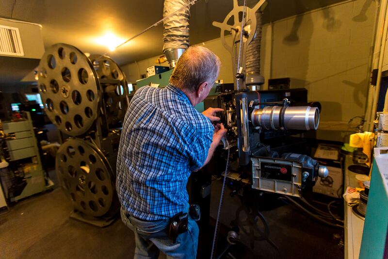 In May 2018, Redwood Drive-In Theatre projectionist Earl Shaffer loads an intermission reel into one of the drive-in's original projectors, which were replaced with digital projectors four years ago.