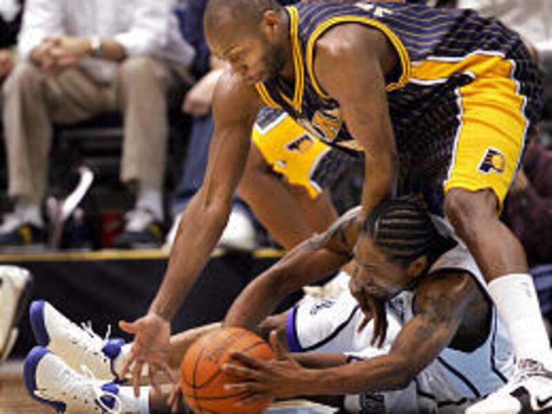 Utah Jazz's Keith McLeod hangs onto the ball as he is guarded by Pacer's Anthony Johnson during the Pacers' win Tuesday.