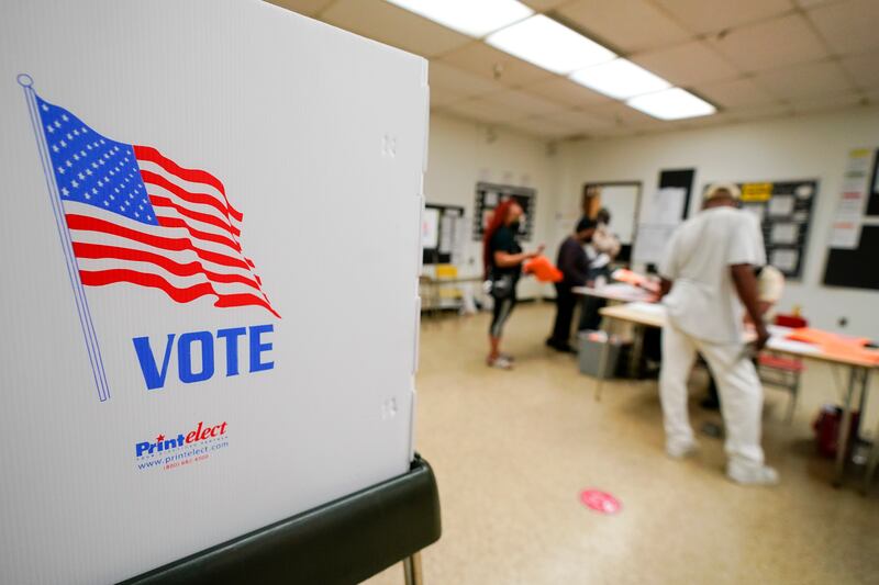People check in to vote at Edmondson Westside High School during Maryland’s primary election on Tuesday in Baltimore.