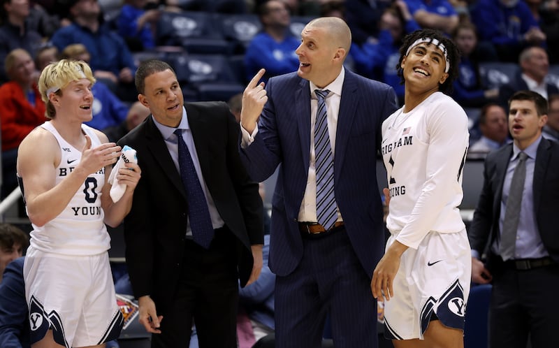 BYU coach Mark Pope enjoys a moment on the sidelines with Trey Stewart during NIT victory over Long Beach State in Provo.