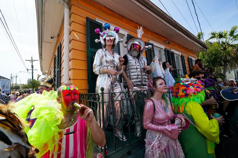 Revelers watch the La Societe de Saint Anne Parade on Mardi Gras Day in New Orleans.
